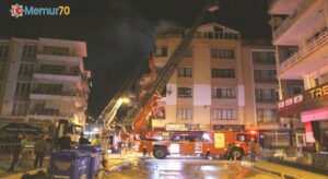 Karşı apartmandaki yangına balkondan hortumla müdahale etti